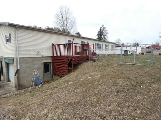 11380 Valley Dr, The Plains, OH 45780 - back of property featuring a wooden deck, a lawn, an attached garage, and fence