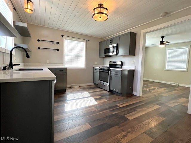 1865 Triumph Ave, Lake Milton, OH 44429 - kitchen with ceiling fan, gray cabinetry, dark wood-type flooring, a sink, and appliances with stainless steel finishes