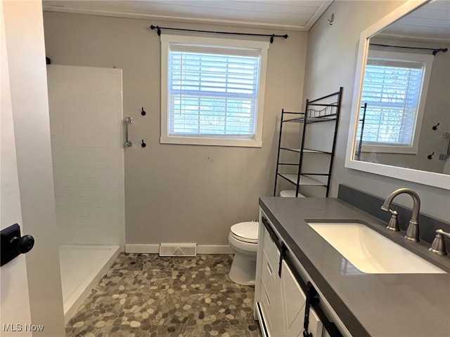 1865 Triumph Ave, Lake Milton, OH 44429 - bathroom with visible vents, toilet, tiled shower, baseboards, and vanity