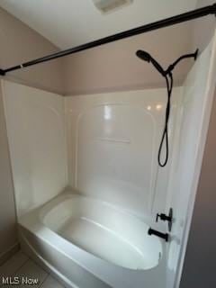 full bath featuring tile patterned flooring and shower / washtub combination