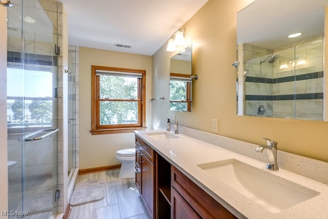 full bathroom with a shower stall, toilet, and a sink