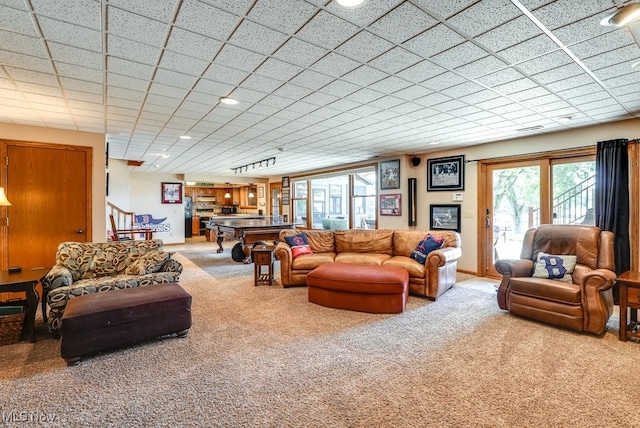 living room featuring stairway, carpet, and baseboards