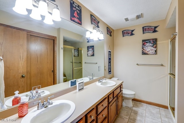 bathroom with a sink, visible vents, toilet, and a stall shower