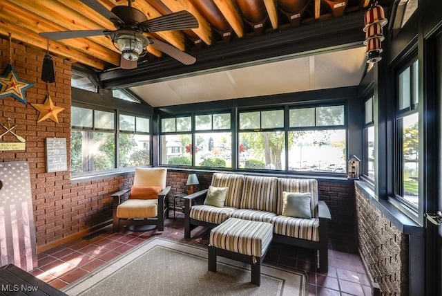 sunroom / solarium with lofted ceiling with beams, a healthy amount of sunlight, and ceiling fan