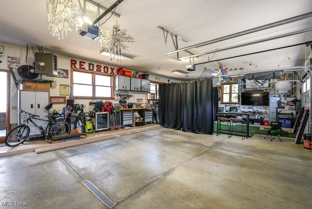 garage with a workshop area and a garage door opener