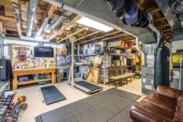 unfinished basement with a workshop area