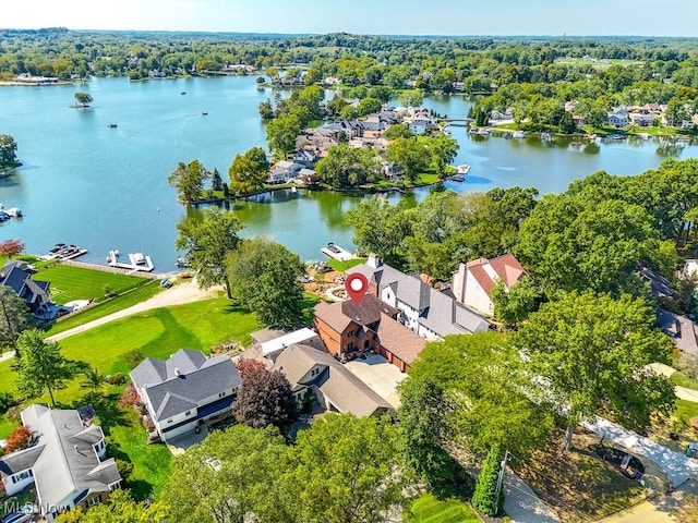 drone / aerial view featuring a residential view and a water view