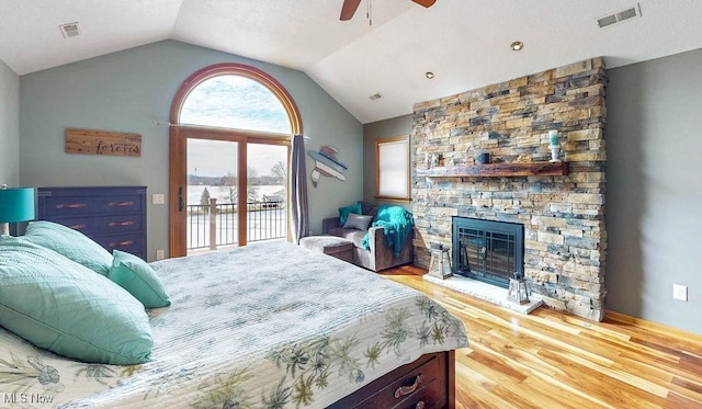 bedroom featuring light wood-type flooring, visible vents, lofted ceiling, and access to outside