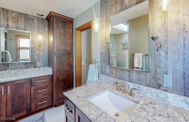 bathroom with a sink and two vanities