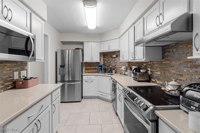 12550 Lake Ave Unit 607, Lakewood, OH 44107 - kitchen featuring under cabinet range hood, light tile patterned floors, stainless steel appliances, and light countertops