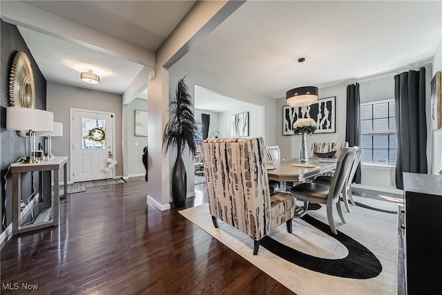 784 Hilliary Ln, Aurora, OH 44202 - dining area with baseboards, dark wood-style flooring, and a notable chandelier