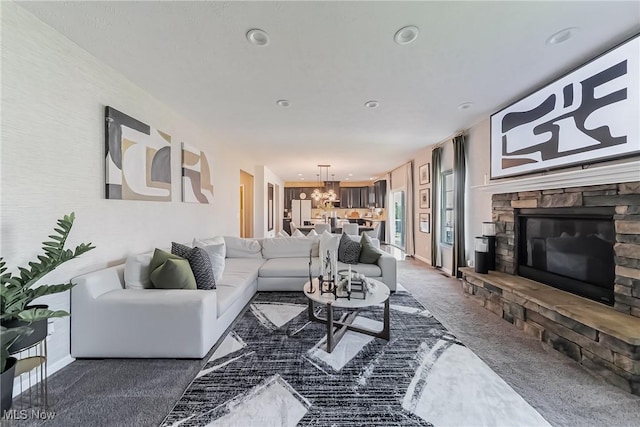 784 Hilliary Ln, Aurora, OH 44202 - carpeted living area featuring a fireplace, an inviting chandelier, baseboards, and recessed lighting