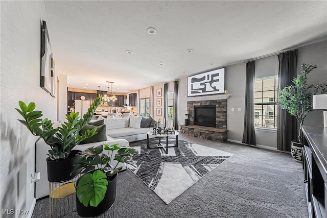 784 Hilliary Ln, Aurora, OH 44202 - living room featuring carpet floors, a stone fireplace, and recessed lighting