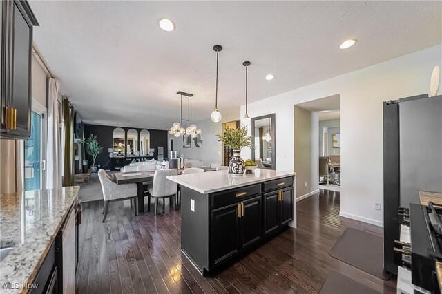 784 Hilliary Ln, Aurora, OH 44202 - kitchen featuring open floor plan, freestanding refrigerator, dark wood-style flooring, dark cabinets, and recessed lighting