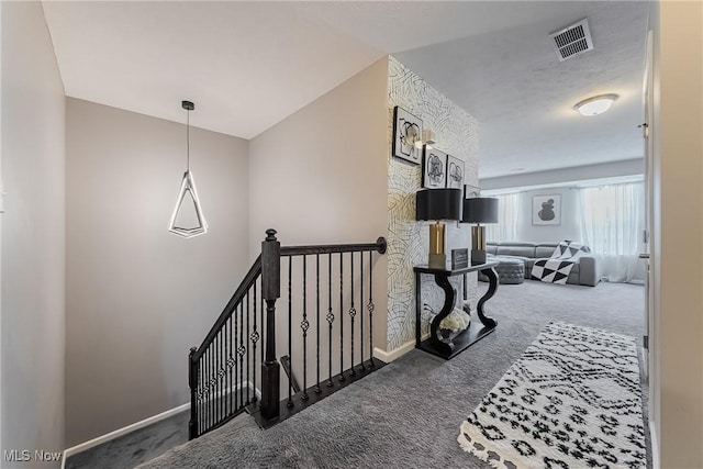 784 Hilliary Ln, Aurora, OH 44202 - corridor with an upstairs landing, carpet floors, baseboards, and visible vents