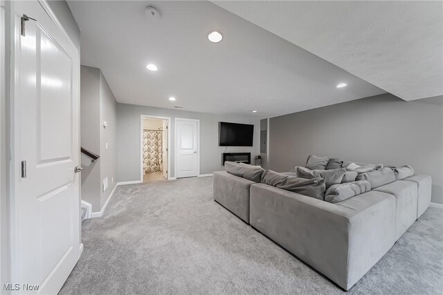 784 Hilliary Ln, Aurora, OH 44202 - carpeted living area with baseboards, recessed lighting, and a glass covered fireplace