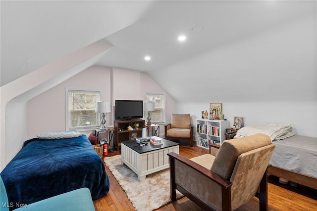bedroom with lofted ceiling, recessed lighting, multiple windows, and light wood finished floors