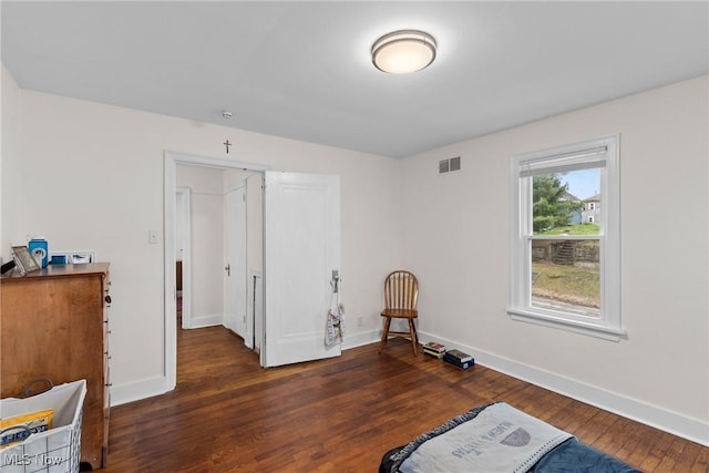 interior space with wood finished floors, baseboards, and visible vents