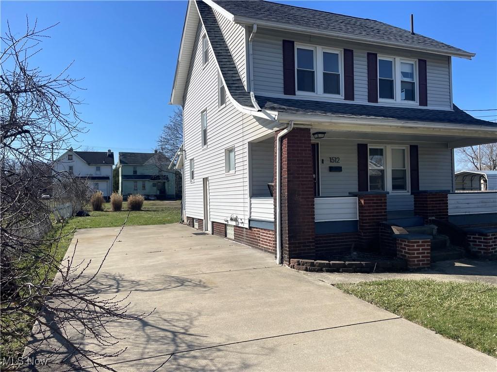 1512 14th St SE, Canton, OH 44707 - view of front of property with roof with shingles, covered porch, and concrete driveway