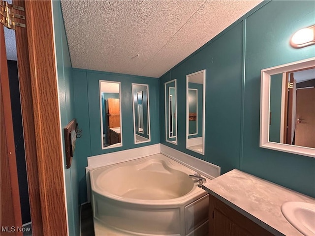 78790 Hamilton Ridge Rd, Freeport, OH 43973 - full bath featuring a textured ceiling, a decorative wall, vanity, and a garden tub