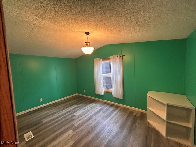 78790 Hamilton Ridge Rd, Freeport, OH 43973 - unfurnished room with dark wood-style flooring, a textured ceiling, and lofted ceiling