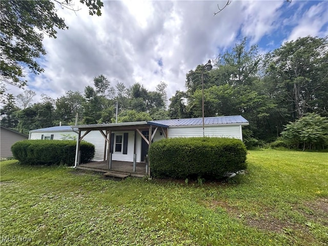 78790 Hamilton Ridge Rd, Freeport, OH 43973 - view of side of home with a yard, a porch, and a metal roof