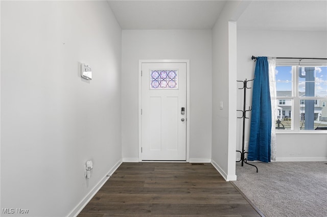 entrance foyer with dark wood finished floors and baseboards