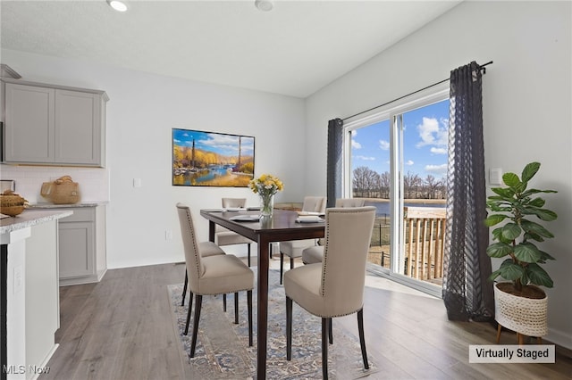 dining area with wood finished floors