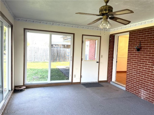 interior space with ceiling fan