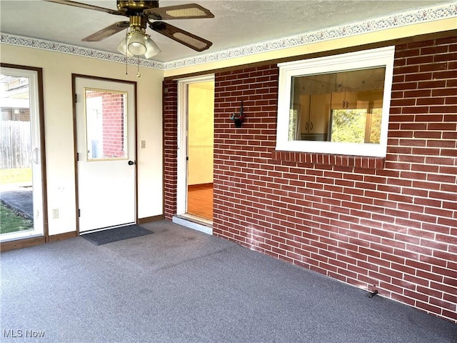 entrance to property featuring ceiling fan