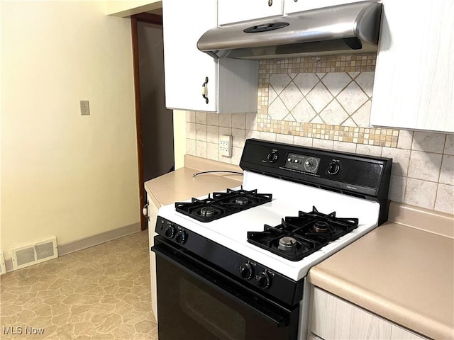 kitchen with visible vents, under cabinet range hood, range with gas stovetop, white cabinetry, and light countertops