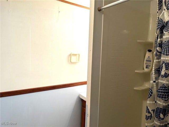 full bath with vanity and a shower with shower curtain