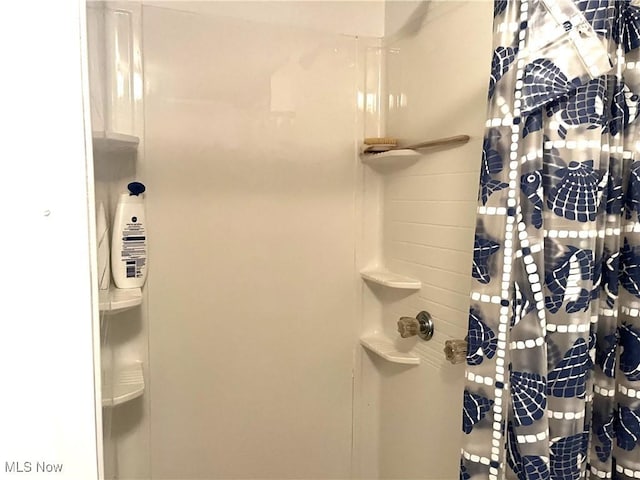 full bath with a shower with shower curtain