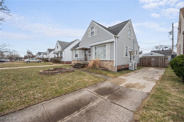 view of front of property with a front lawn, fence, driveway, and crawl space