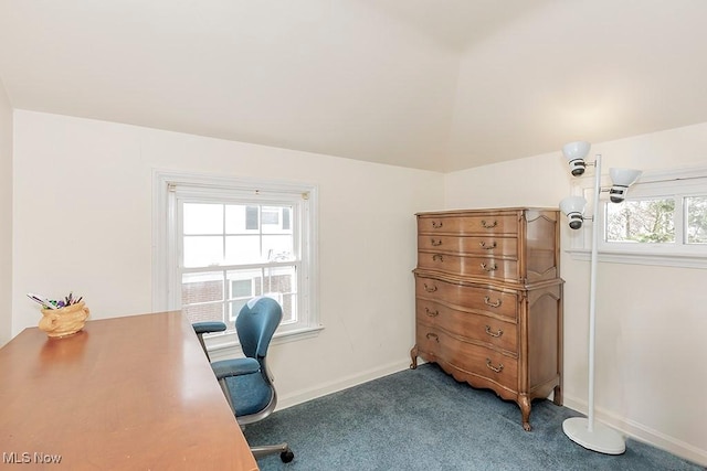 carpeted home office featuring lofted ceiling and baseboards