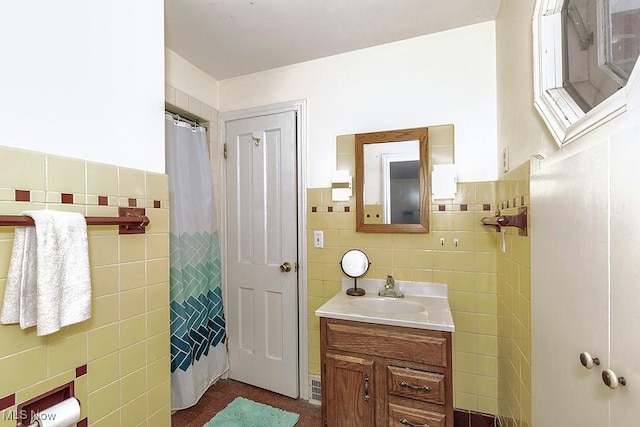 full bath with vanity, tile walls, and a shower with curtain