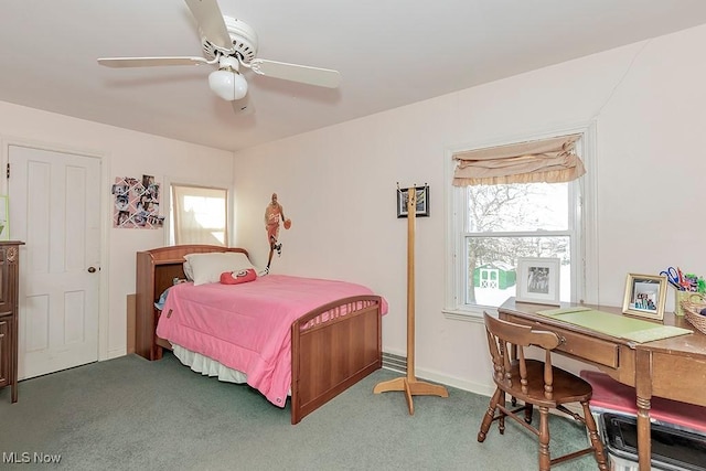 carpeted bedroom with ceiling fan and baseboards