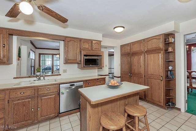 kitchen featuring open shelves, light countertops, appliances with stainless steel finishes, and a sink