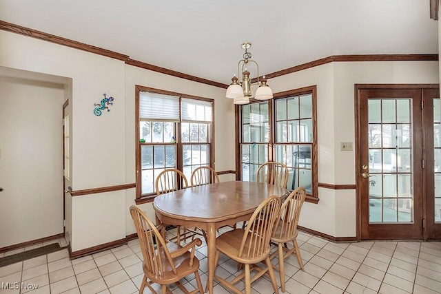 dining space featuring light tile patterned floors, baseboards, a notable chandelier, and crown molding