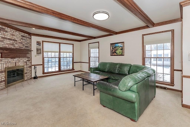 living room featuring beam ceiling, plenty of natural light, visible vents, and carpet floors