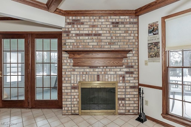 unfurnished living room with baseboards, beamed ceiling, ornamental molding, light tile patterned floors, and a fireplace