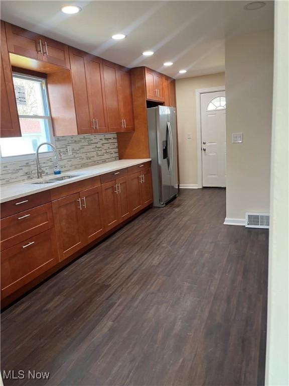366 Tenney Ave, Campbell, OH 44405 - kitchen featuring visible vents, a sink, light countertops, stainless steel fridge, and dark wood-style flooring