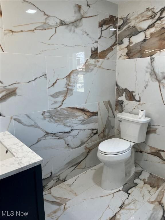 366 Tenney Ave, Campbell, OH 44405 - bathroom with marble finish floor, toilet, stone wall, and vanity