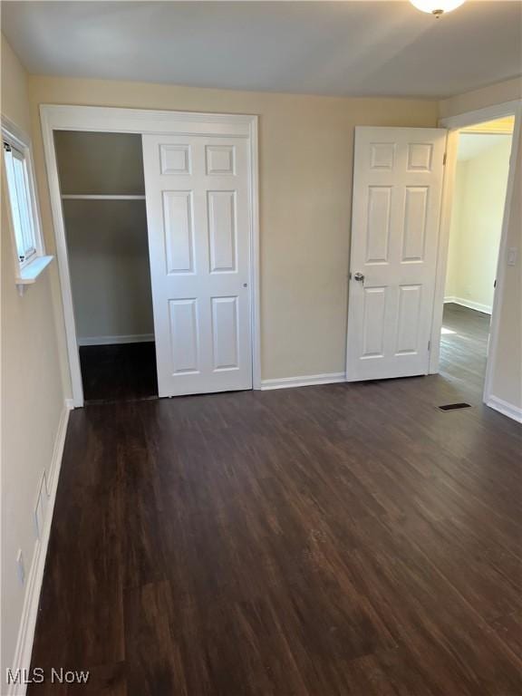 366 Tenney Ave, Campbell, OH 44405 - unfurnished bedroom with a closet, baseboards, and dark wood-type flooring
