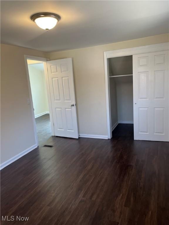 366 Tenney Ave, Campbell, OH 44405 - unfurnished bedroom featuring a closet, visible vents, baseboards, and dark wood-style flooring