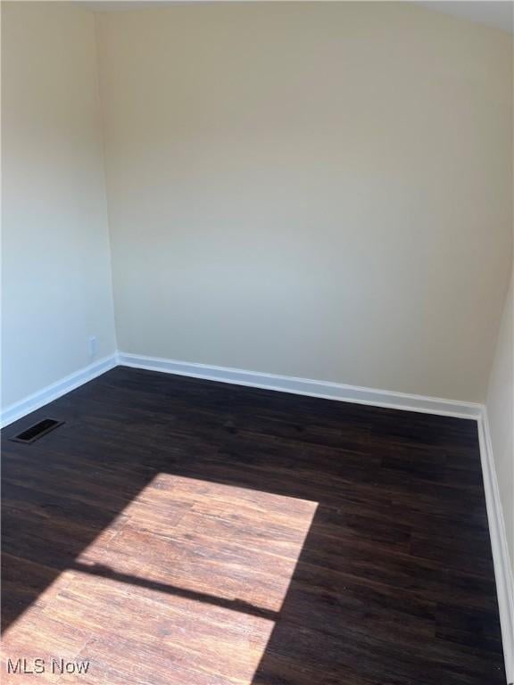366 Tenney Ave, Campbell, OH 44405 - unfurnished room with baseboards, visible vents, and dark wood-style flooring