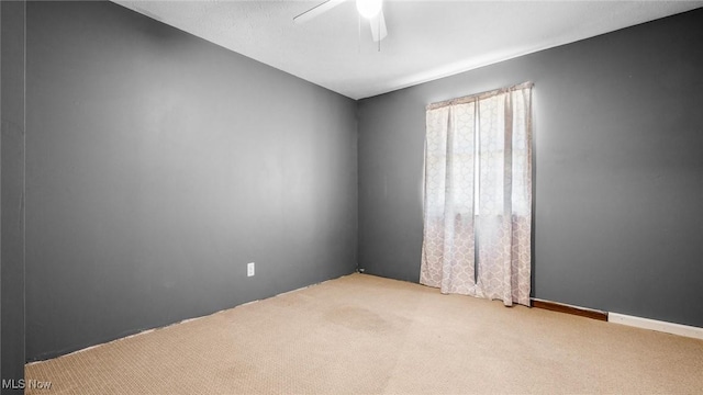 empty room featuring carpet flooring and ceiling fan