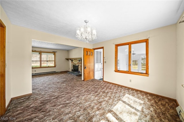 unfurnished living room with baseboards, carpet, a chandelier, baseboard heating, and a fireplace