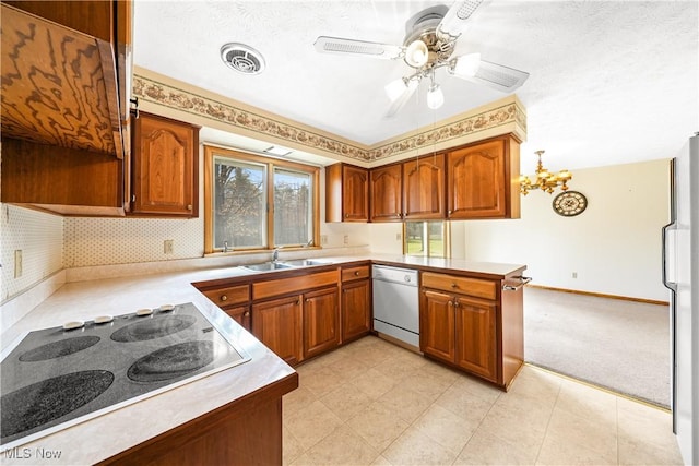 kitchen with a sink, dishwashing machine, black electric stovetop, and brown cabinetry