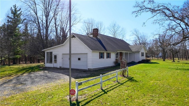 view of property exterior with fence, driveway, an attached garage, a chimney, and a lawn